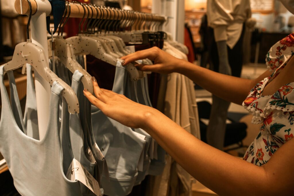 Clothing rail with clothes being separated on their hangers.